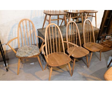 A set of eight Ercol high hoop back beech and elm dining chairs comprising two carvers and six others (8).There are no splits