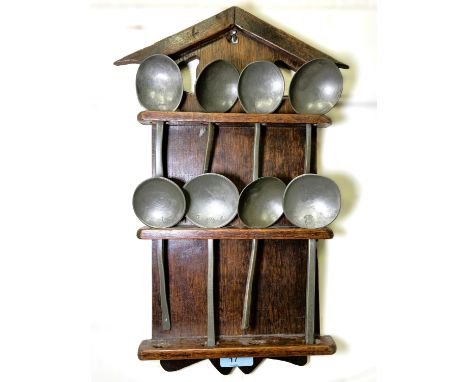 A collection of antique slip top and other pewter spoons, 8 in total on shelf, some with stamps to bowl.