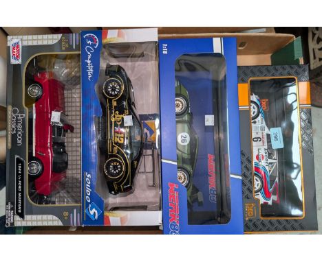 Four originally boxed scale model racing/sports cars.