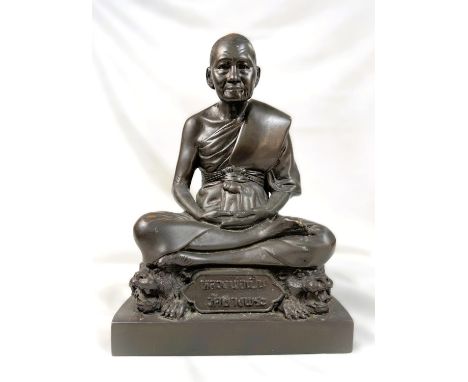 A 20th century bronze depicting seated Thai buddha atop lions with text to sash and seals inset into the base, height 26cm.