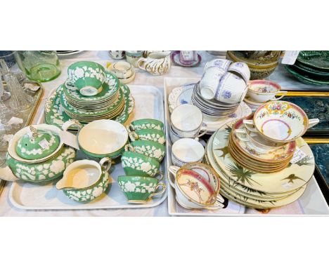A crescent part tea service in green and raised white (approx. 22 pieces); a ribbed lilac part tea set; a near matching 12-pi