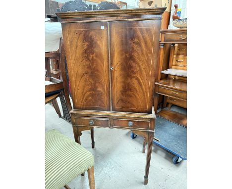 A repro figured mahogany drinks cabinet with twin cupboard and lower drawer.