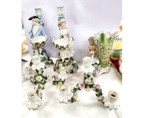 A pair of 19th century 4 branch candelabra heavily encrusted with roses and foliage, a young man to one and a young woman to 