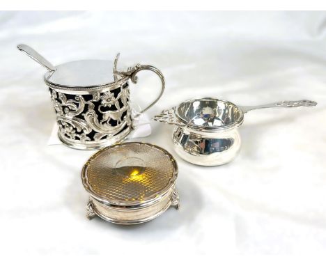 A circular engine turned hallmarked silver trinket box on three feet and a silver plated mustard pot.