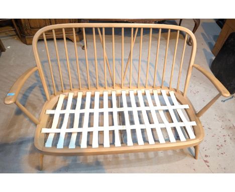 An Ercol beech and elm blonde stick back two-seater settee, length 130cm.