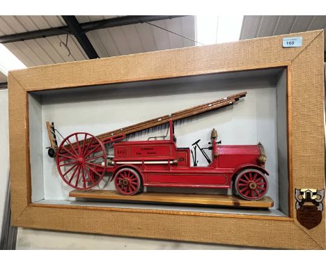 A relief wooden picture of a vintage 'Dennis' fire engine framed, 49 x 85cm.