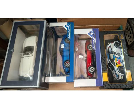 Four originally boxed scale model racing/sports cars.