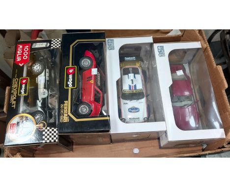 Four originally boxed scale model racing/sports cars.