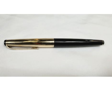 A vintage Mont Blanc Meisterstuck 72 fountain pen with semi hooded nib and amber coloured ink window, white star to base and 