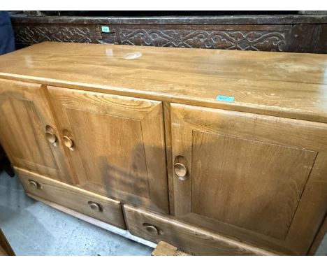 An Ercol light elm sideboard comprising three cupboards and two drawers, length 129cm