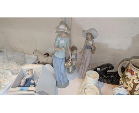 A Lladro figure, 'Pretty Pickings', S222, in original box; two large Nao figures of women, a small Nao boy and similar figure