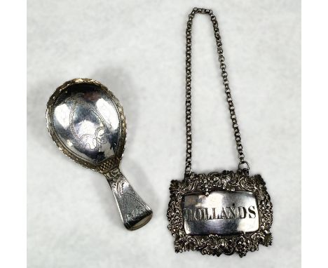 A hallmarked silver "Hollands" bottle label; an ornate teardrop shaped hallmarked Georgian silver caddy spoon.