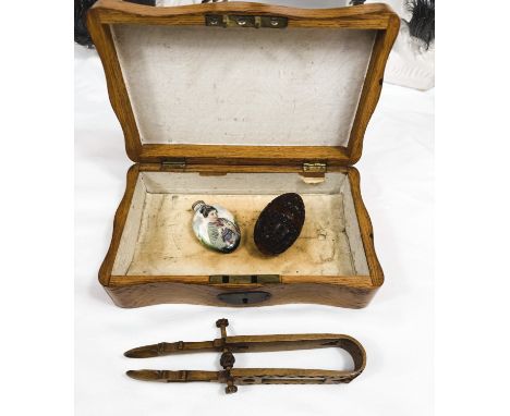 A wooden jewellery box with contents including Welsh 'Love&nbsp; Tongs' with date 24th December 1892, a carved and pierced eg