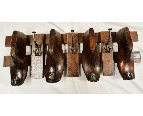 A hat and coat rack in the form of a vintage cobblers shoe lasts on rack, 76cm.