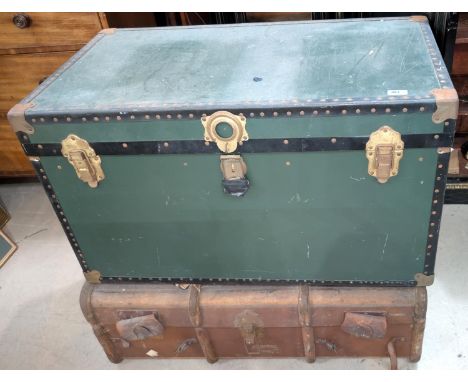 A large travel trunk and a wood bond travel case.