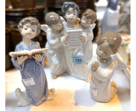 Lladro figures, Angel Choir, no. 4542, Praying Angel, no. 4538, and Reading Angel, no. 5724.
