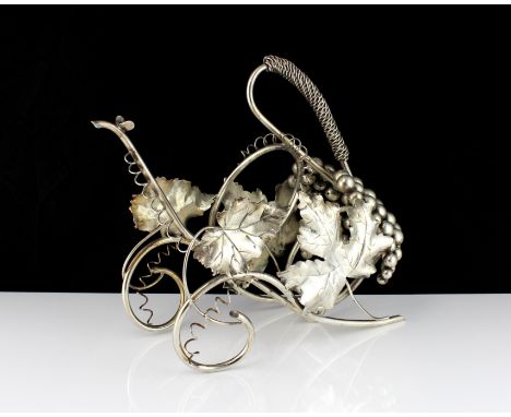 A vintage Italian 800 Silver wine bottle holder circa 1960. The wirework carriage body with realistic grape and wine decorati