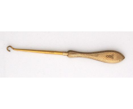 An antique 9ct yellow gold button hook by Mappin & Webb, the gold handle with finely engine turned decoration surrounded by a