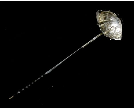 An antique George II Sterling Silver toddy ladle circa 1740 with stylised serpentine bowl featuring high relief floral decora