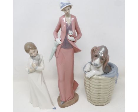 Two Nao figurines and a Lladro dog in basket, no cracks or chips, largest H: 31 cm. UK P&amp;P Group 3 (£30+VAT for the first