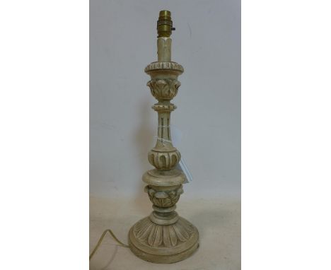 A carved wooden candlestick converted to a table lamp, with floral decoration, no shade, H.50cm 