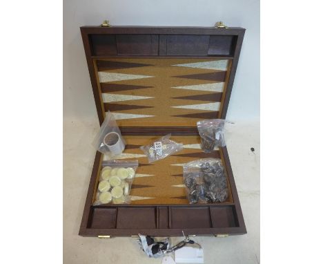 A Crisloid Tournament Attaché backgammon set, with checkers, dice and dice cups, in an attaché case, handle broken 