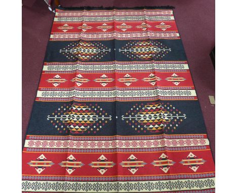 A large modern reversible carpet with multi coloured geometric design, 300 x 197cm 