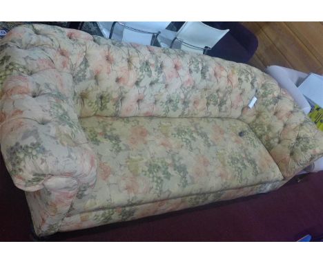 A Victorian 3 seat Chesterfield sofa, with floral upholstery, raised on carved legs and castors 