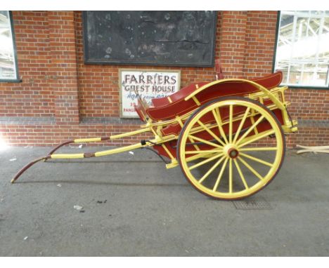 MILK FLOAT to suit 14.2 to 15hh. Painted red and yellow, with matching lines, and black metal work. On 47.5ins/16-spoke wheel