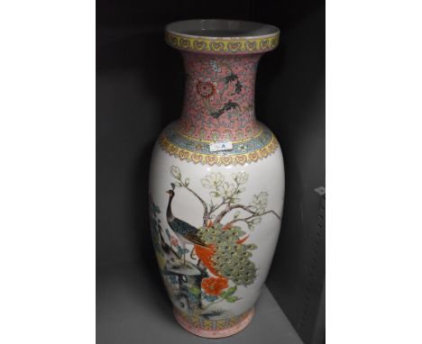 A large standing Cantonese styled floor vase having peacock enamel scene and standing at 60cm tall