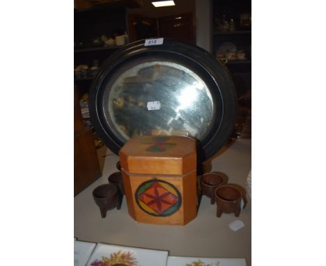 An oval ebony framed Victorian mirror and tea caddy