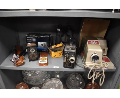 An assortment of cameras,binoculars,Cine Kodak and an Aldis projector.