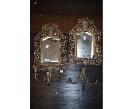 Two antique bevelled glass mirrors having filigree gilt edging and integrated candlestick holders.AF