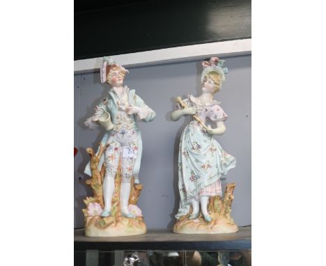 Pair of Edwardian figures of a Lady with Umbrella and man with floral basket decorated with floral sprays. 40cm in Height 