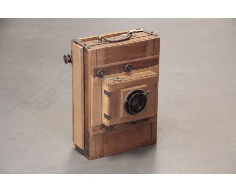 An Unmarked Continental Wooden Tailboard Camera, with Goerz Dagor Series III f/6.8 135mm lens, lacking back