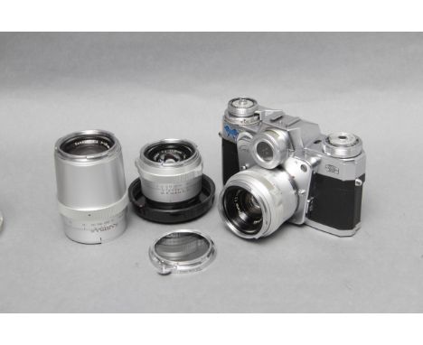 A Zeiss Ikon Contarex 'Bullseye' SLR Camera, with Carl Zeiss Planar f/2 50mm, Carl Zeiss Distagon f/4 35mm and Carl Zeiss Son