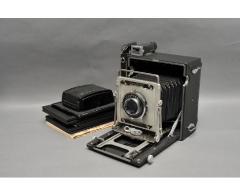 A Graflex Crown Graphic Camera, with Optar f/4.7 135mm lens, together with three DDS and one rollfilm back