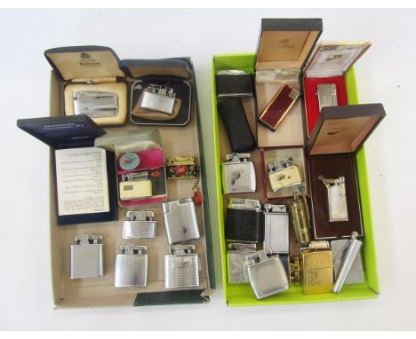 Two vintage Zippo pocket lighters, one with camel decoration, and a quantity of other lighters including a brass Trench Art-s
