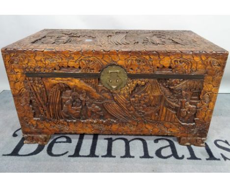 A modern Chinese carved camphor wood trunk, 101cm wide x 57cm high. 