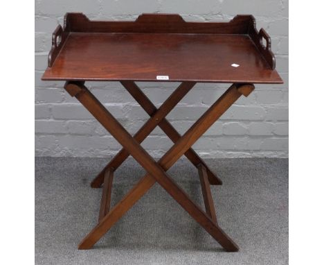 An early 19th century mahogany butler's tray, with three quarter gallery on folding stand, 87cm wide x 73cm high. 