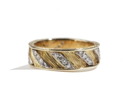 A gold and diamond set band ring, mounted with rows of four circular cut diamonds in a slanting design, otherwise having a ba