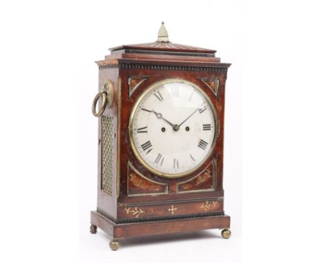 An early 19th century mahogany and brass inlaid bracket clock, with eight inch painted tin dial and twin brass ring handles, 