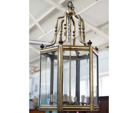 A Victorian style gilt metal hall lantern of hexagonal form, with bevelled glass panels and an internal five light fitment, 1