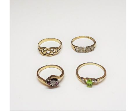 A 9ct gold, ruby and diamond three stone ring, in a crossover design, a 9ct gold, peridot and diamond ring, in a twist design