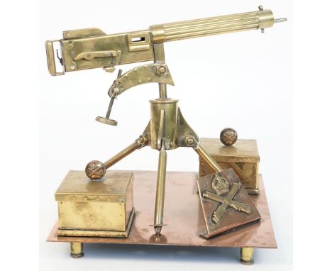 A brass model of a WWI Vickers machine gun, 20th century, with two ammunition boxes and covers on a square copper base and fo