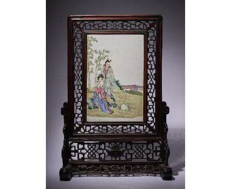 A Chinese famille-rose rectangular porcelain plaque, 20th century, painted with a woman seated on rocks with a man standing a