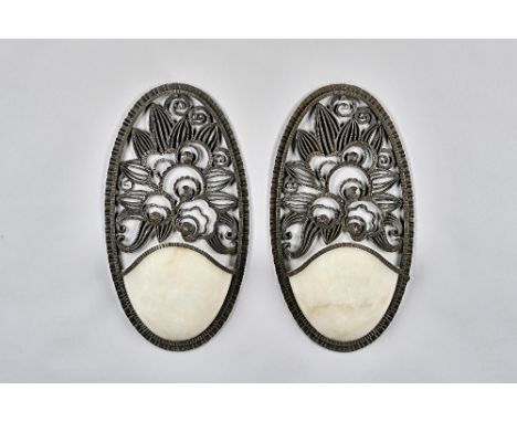 Raymond Subes attributed, a pair of French wrought iron and marble mounted wall lights, each backplate of oval form with foli