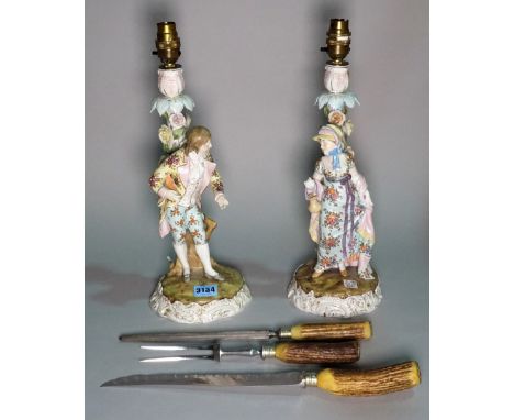 A pair of early 20th century continental ceramic figural table lamps, 38cm high, and an early 20th century antler mounted thr