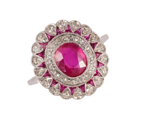 A ruby and diamond ring, mounted with the principal cushion shaped ruby to the centre, in a surround of cushion shaped diamon