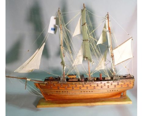A modern wooden model of a triple mast galleon, 80cm wide x 78cm high.